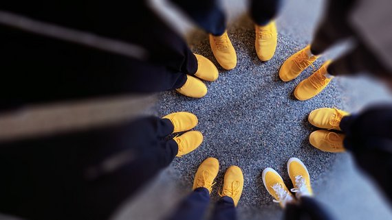 Top view of yellow shoes arranged in a circle.